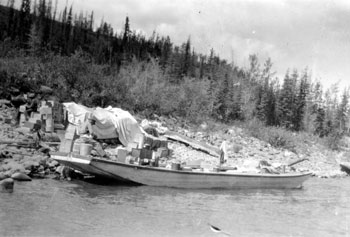 “See the cook? He′s very busy peeling ‘spuds’ for dinner.” The “cook”, Pete Picard, is seated on the rear of the scow.