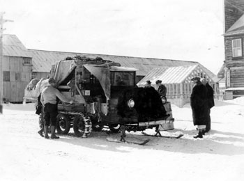 “Another mode of travel in the Yukon in winter. Mail and passengers leaving Mayo by snowmobile Spring 1936.”