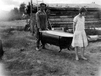 “We carry it indoors once a week.” Claude and Mary haul the bathtub into their home at Ross River.
