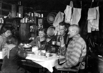 “Xmas Dinner at Pelly Banks 1929.” Claude and Mary Tidd having Christmas dinner with Pete Bockseth and his family.