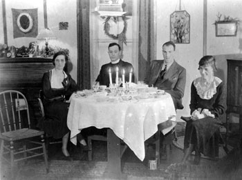 New Year 1933. Mary, A.C. McCullum, RCMP officer Roy Thomas, and an identified woman celebrate at the Tidd residence in Mayo.