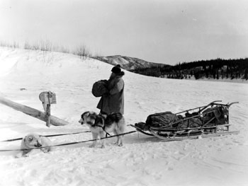 “Arriving at 12-Mile with our mail.” DeWolfe delivers mail to the Tidds. ca. 1938