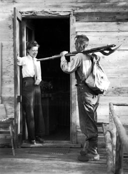 “Here I am leaving home armed with shovel, axe and rifle – in case of a bear!” Mary and Claude at their lopsided cabin at Rock Creek.