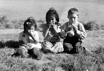 Dorothy Netro, Kathleen Netro and Norman MacDonald of Old Crow feast on oranges.