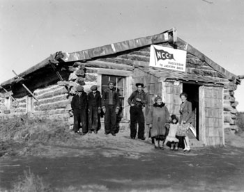 “Our Post isn’t so appealing to the eye but – Just look at the ‘decorations’ in front!” Mary and other Old Crow residents outside the NCCo. store.