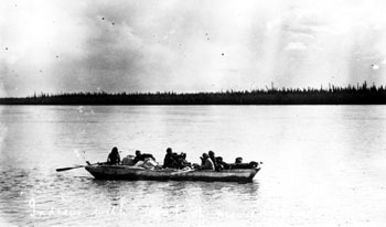 A group of people in a moose-skin boat on the Porcupine River near Old Crow.