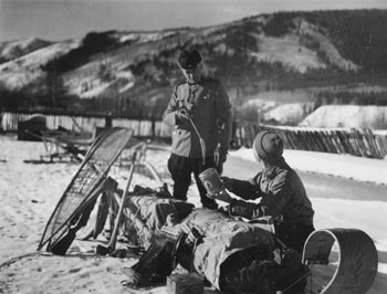 “The Mounty [sic] as Customs Officer.” Check out the composition in this photo: the diagonal, vertical and horizontal lines created by the sled, the standing Mountie (Joe Kessler) etc.

